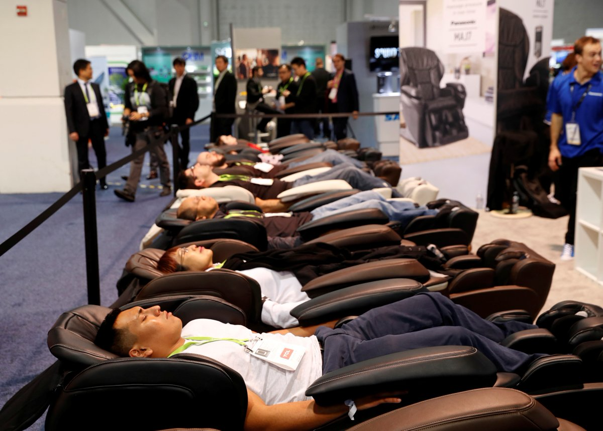 Attendees try out the Panasonic MAJ7 massage chair.