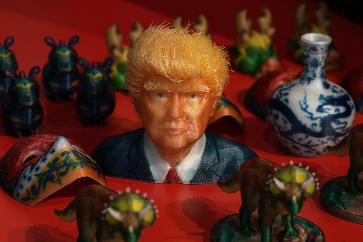 3D print outs, including U.S. President Donald Trump, are displayed.